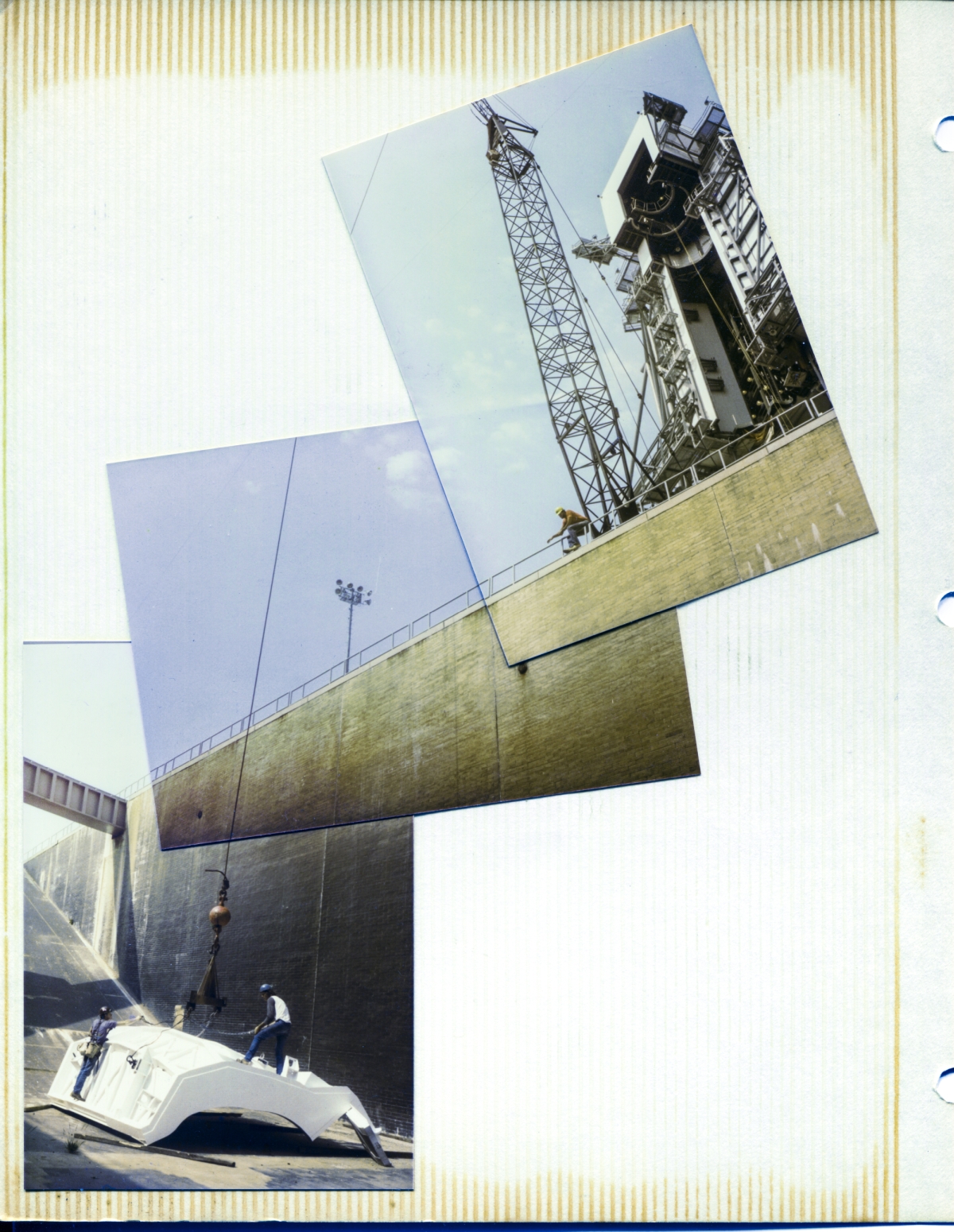 Image 056. Panorama from floor of Flame Trench with OMS Pod Heated Purge Covers to top of RCS Room on RSS. Union Ironworkers from Local 808 working for Ivey's Steel Erectors unhook the Left OMS Pod Heated Purge Cover from its lifting sling shortly after it came to rest in the bottom of the Flame Trench, where it was placed after delivery to the Pad, for safekeeping, in an out-of-the-way location so that further preparation work on it could be done prior to it's getting lifted back out of the Flame Trench and hung on a pair of very small haunches on the modified perimeter framing steel at the 135'-7” elevation on the RSS. Above, hanging over a five-story precipice, ironworker general foreman Rink Chiles watches the work intently while giving hand signals to the crane operator, unseen behind him, who is completely blocked from seeing any of what his crane hook with a lifting sling attached to it is doing in life-threatening proximity to the two ironworkers who are handling the load with this lift. Beyond that, the Great Rotating Service Structure at Launch Complex 39-B, Kennedy Space Center, Florida, looms over the upstanding crane boom and everything else before it and beneath it. Photo by James MacLaren.